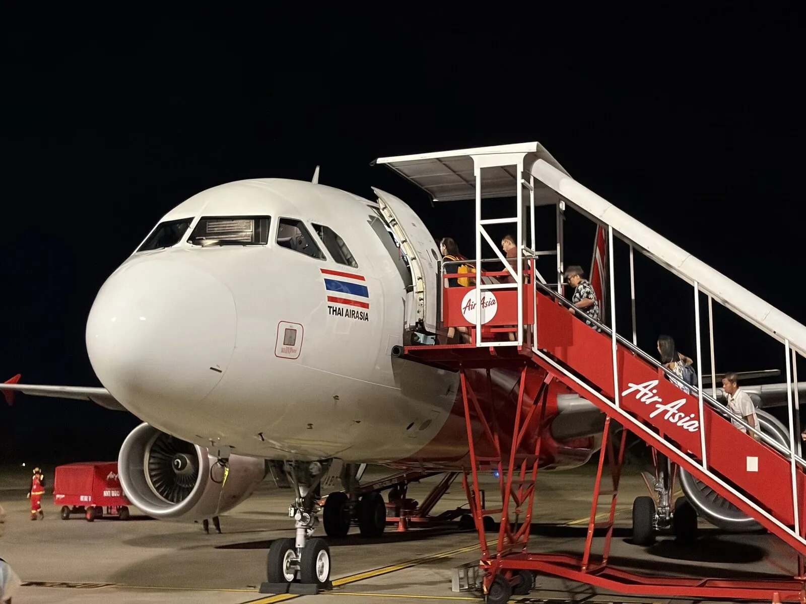 An AirAsia passenger plane at the airport at night