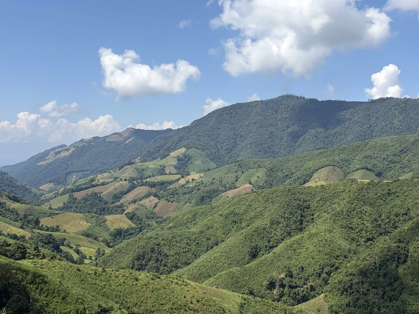 Green mountain ridges and valleys under a cloudy sky
