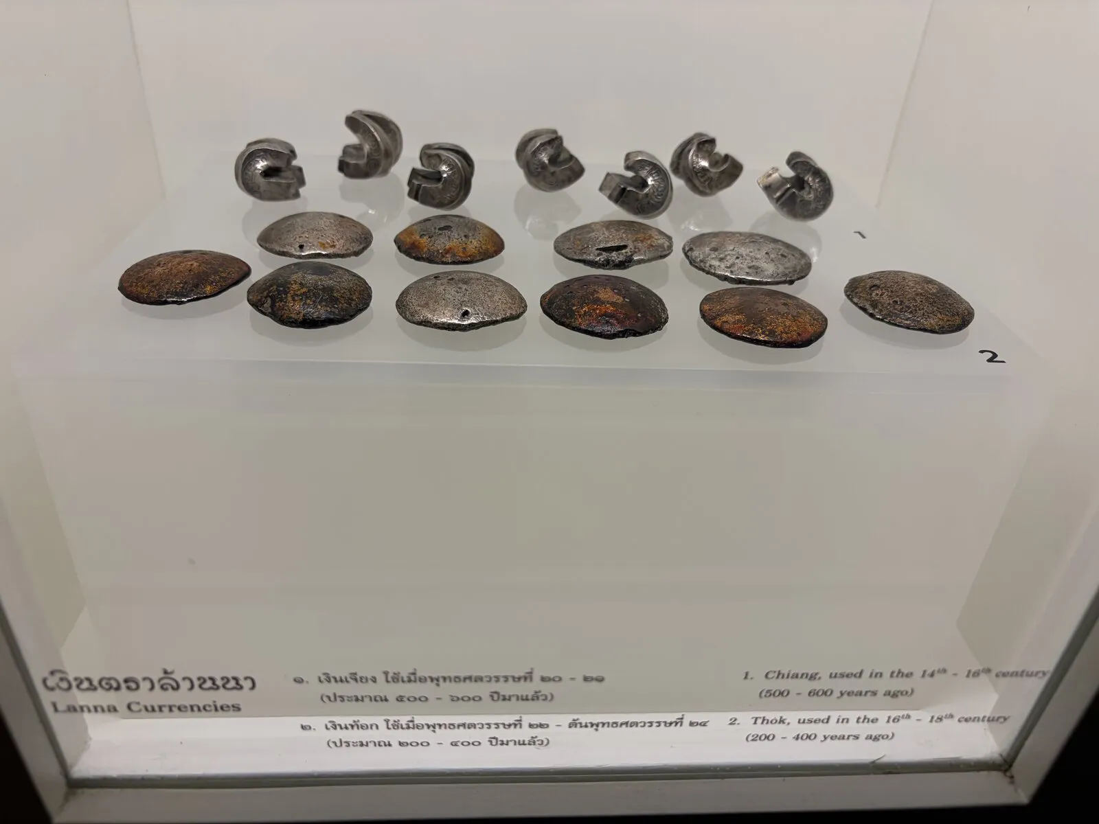 A museum display case holding small artefacts and labels