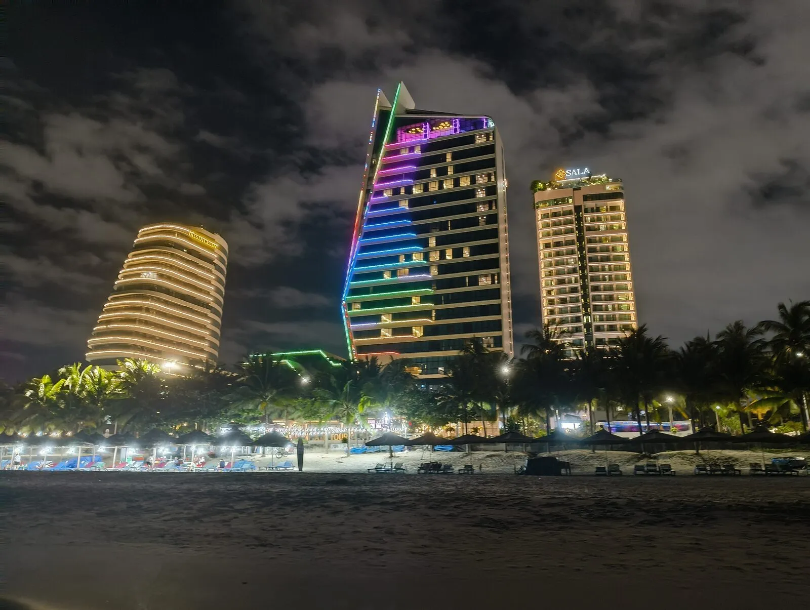A colourful high-rise skyline lit up at night