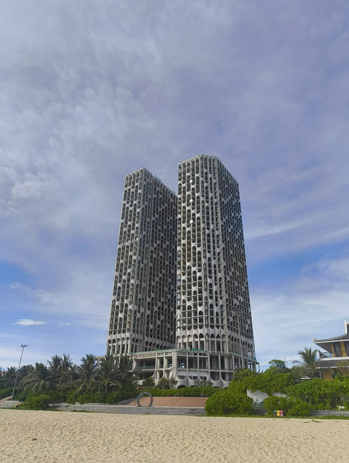 A tall patterned tower rising above the beach