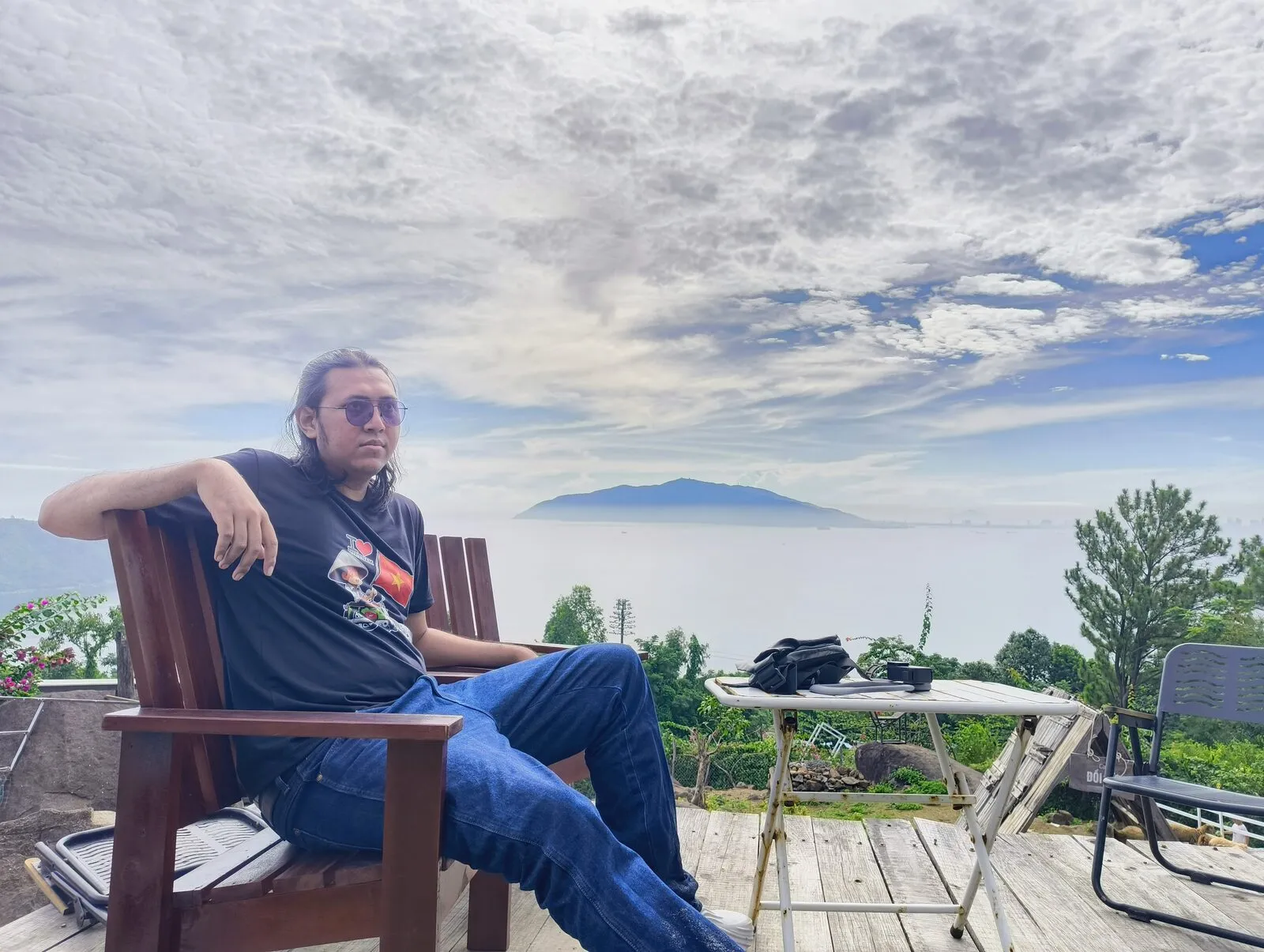 A rider sitting on a wooden chair overlooking the sea